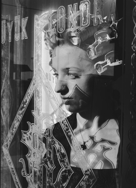 The Woman in Curlers Looking out a Window